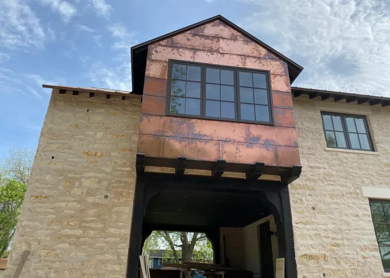 Copper metal panel facade on a stone building for Skylight Installation in Port Charlotte